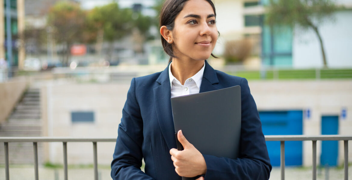 Happy businesswoman holding folder